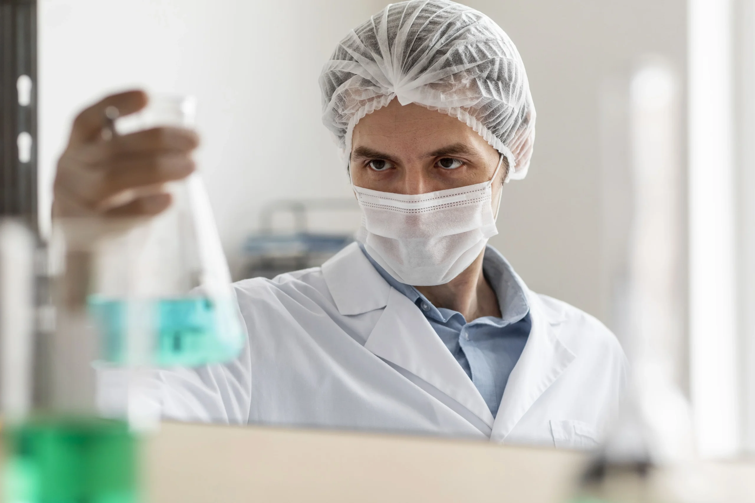 scientist-holding-flask-close-up